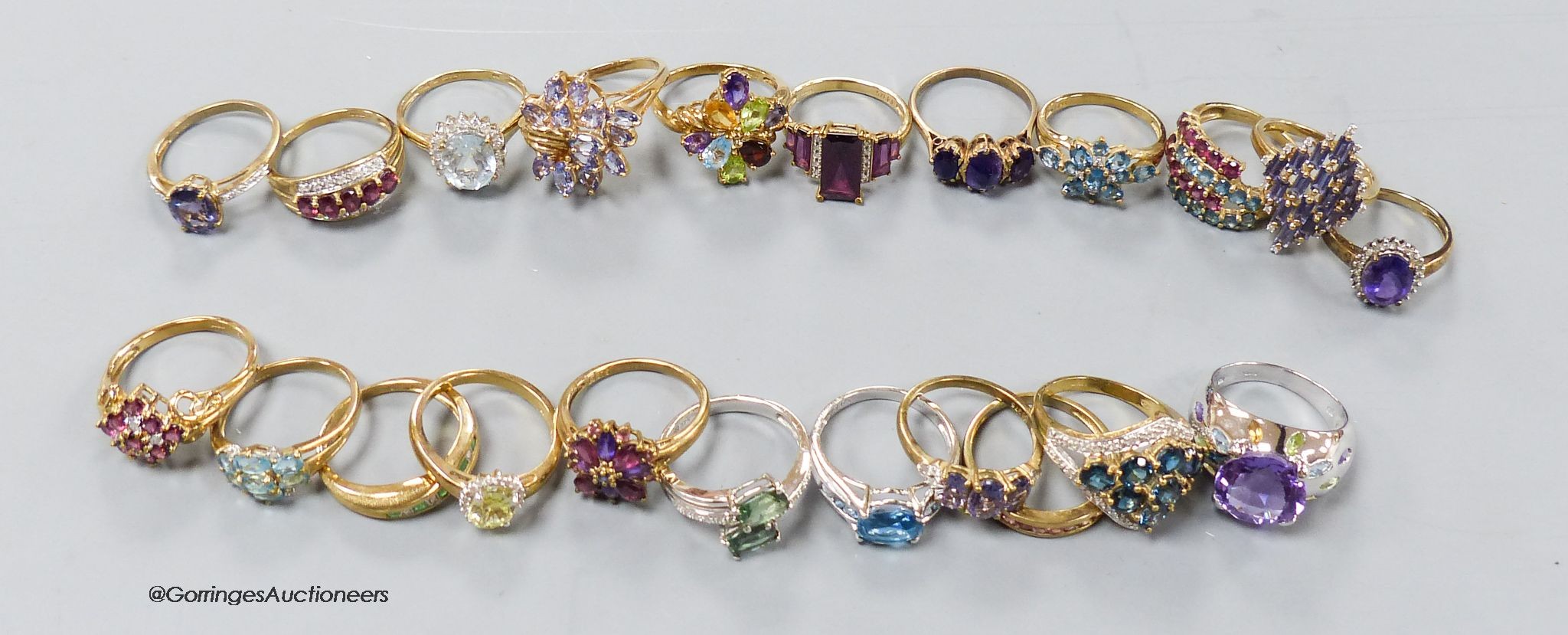 Twenty two assorted modern 9ct or 9k and gem set dress rings, gross 72.5 grams.
